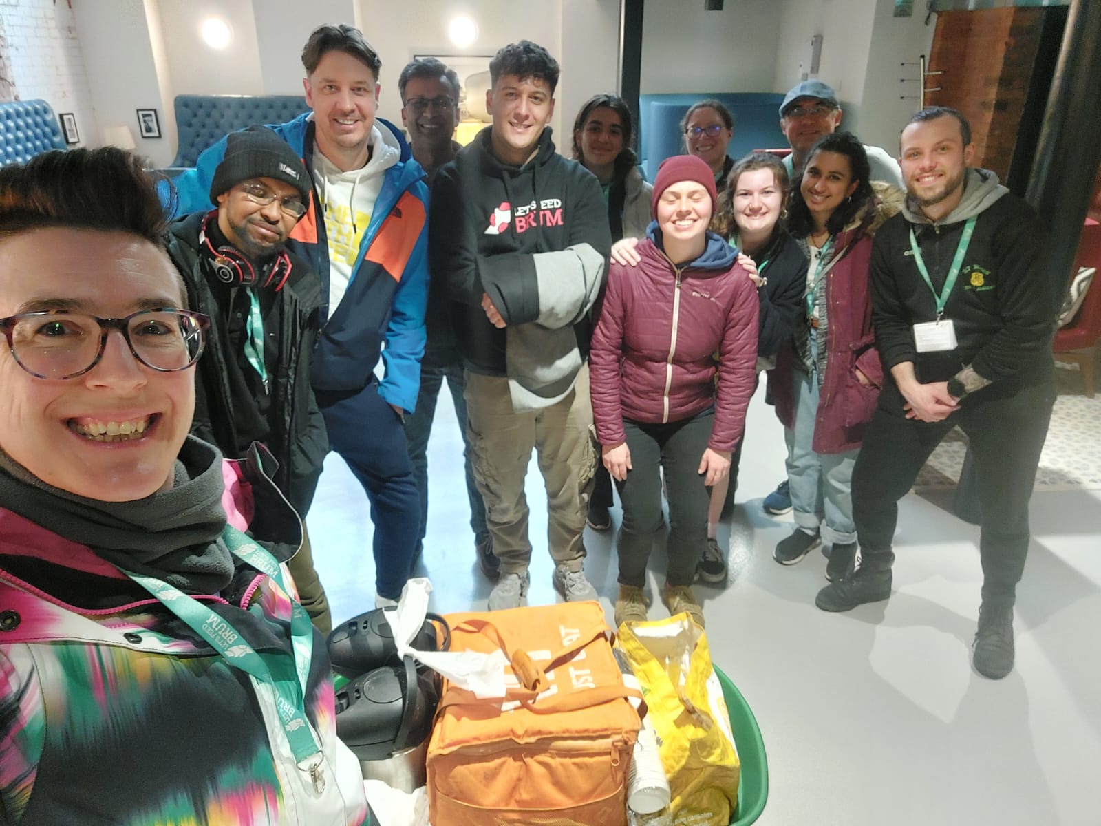 A group of Let's Feed Brum volunteers smiles at the camera as they prepare to go on walkabout.